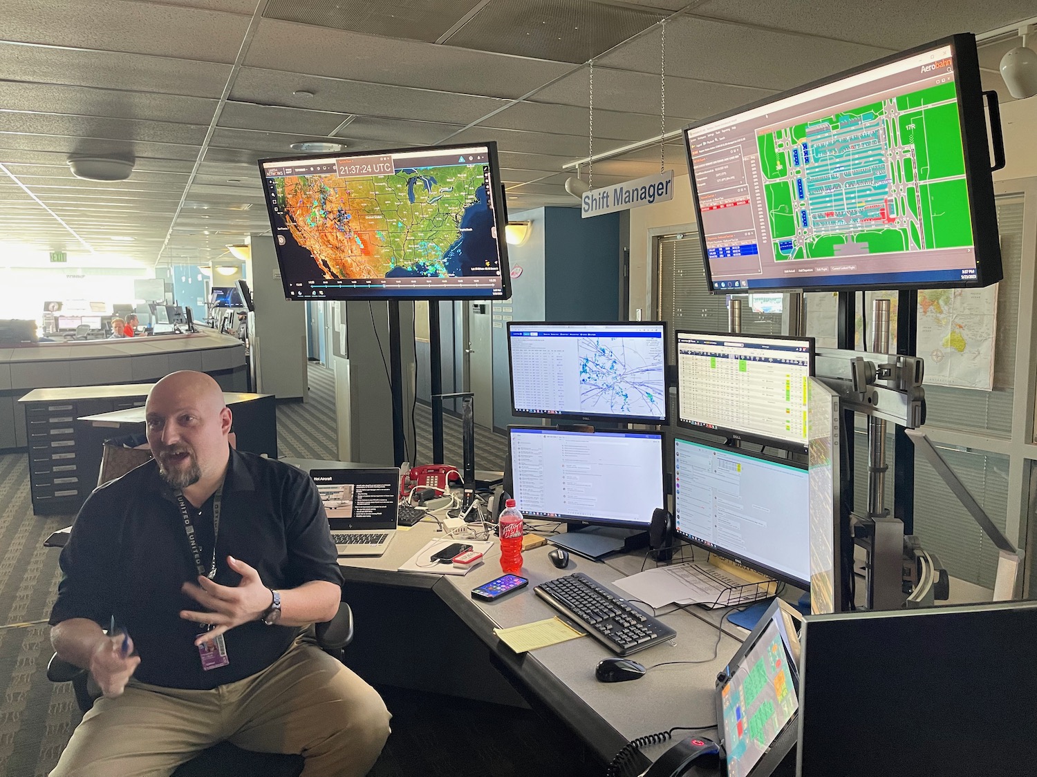 a man sitting in front of multiple monitors