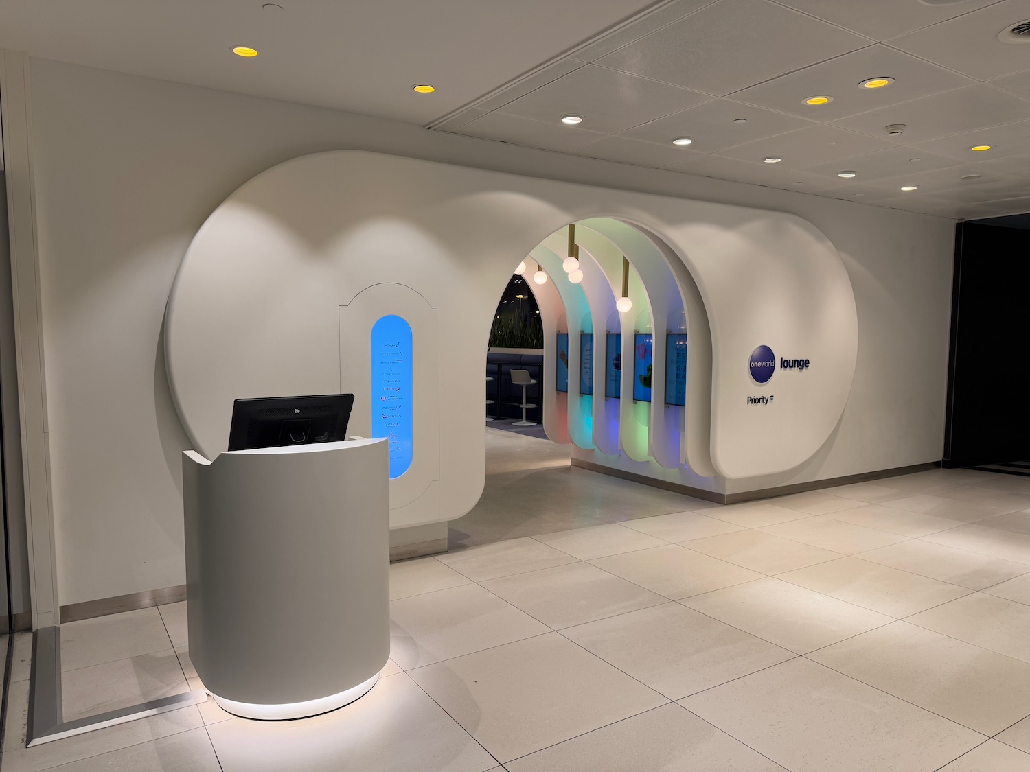 a white room with a computer desk and colorful archways