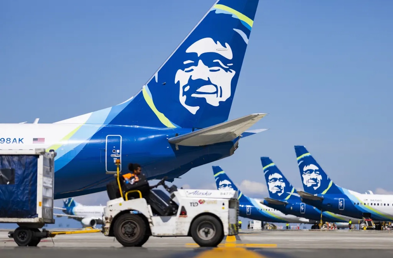 a group of airplanes on a runway