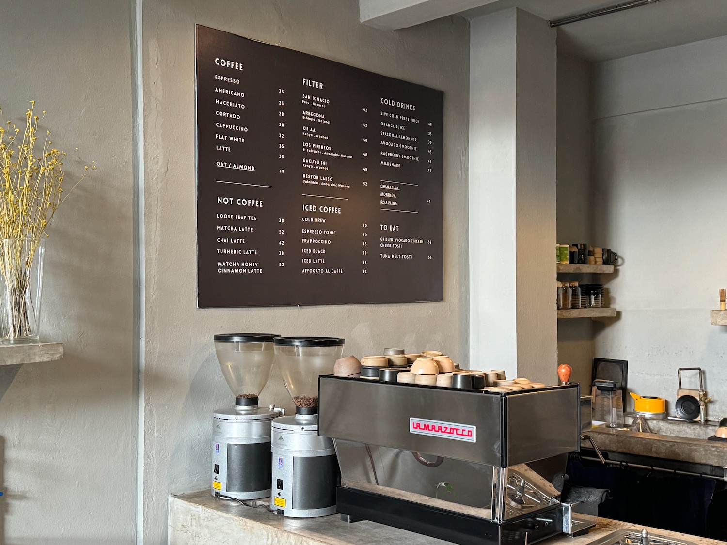 a coffee machine and a menu board