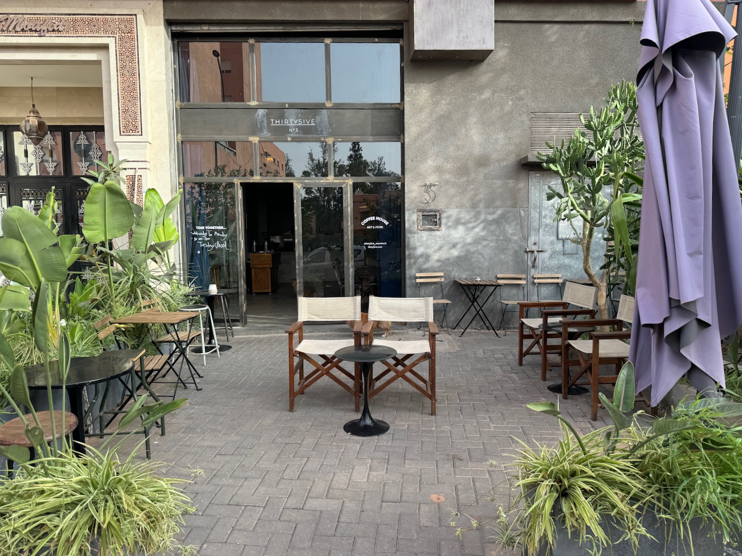 a patio with chairs and tables