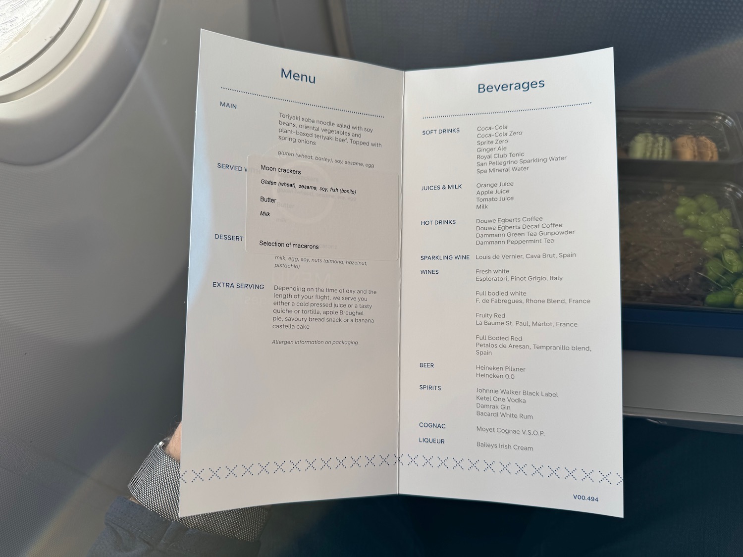 a hand holding a menu