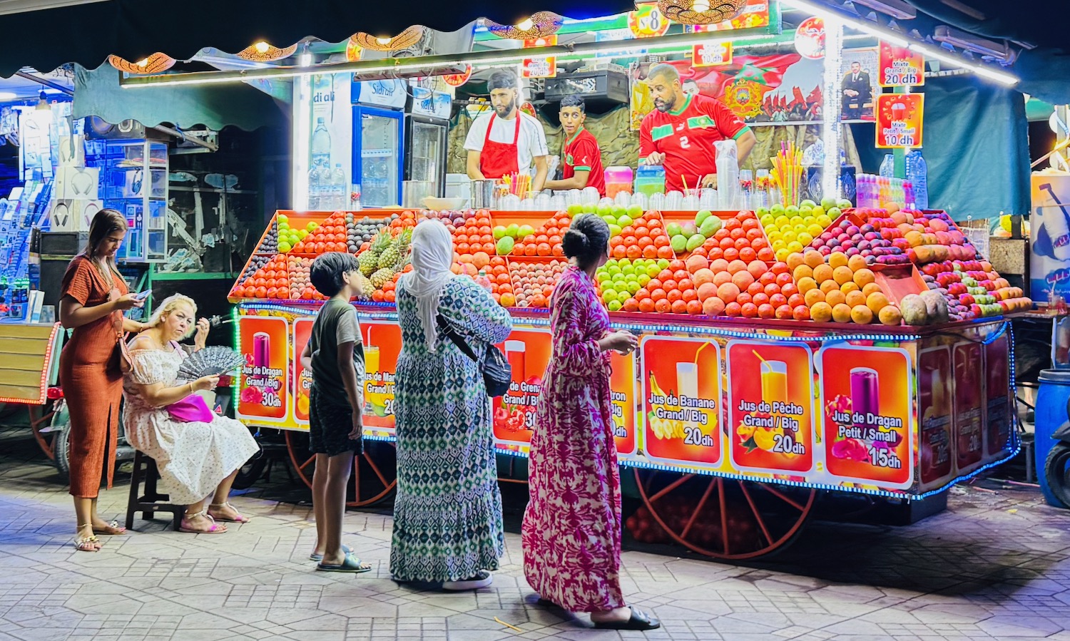 people standing in front of a fruit stand