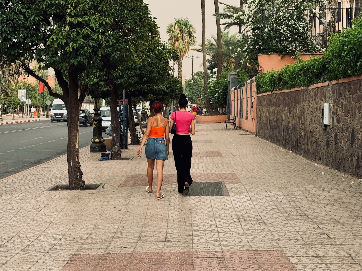 two women walking on a sidewalk