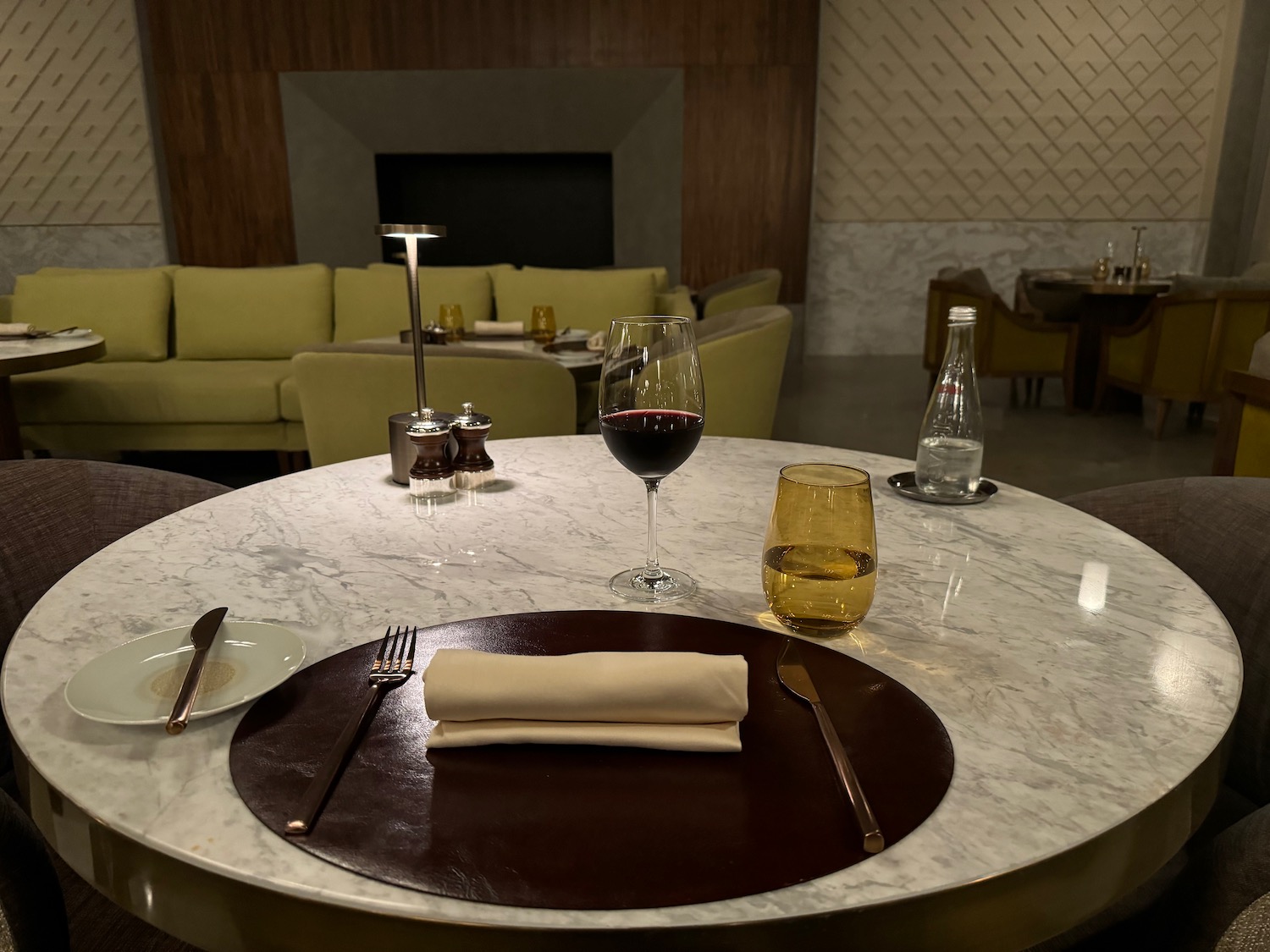 a table with a glass of wine and a napkin on it
