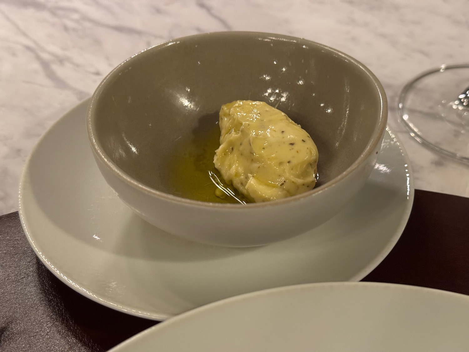 a bowl of butter on a plate