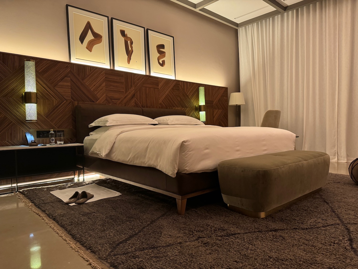 a bed with a foot rest and a foot stool in a room
