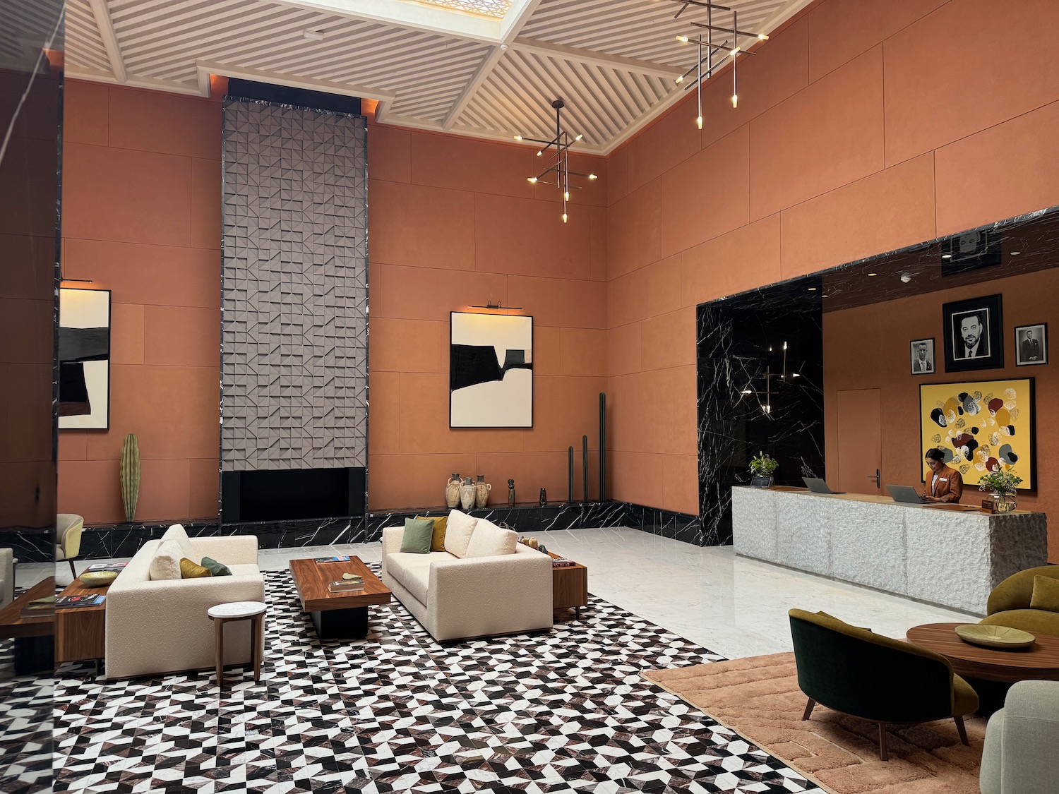 a room with a large wall and a large table and chairs