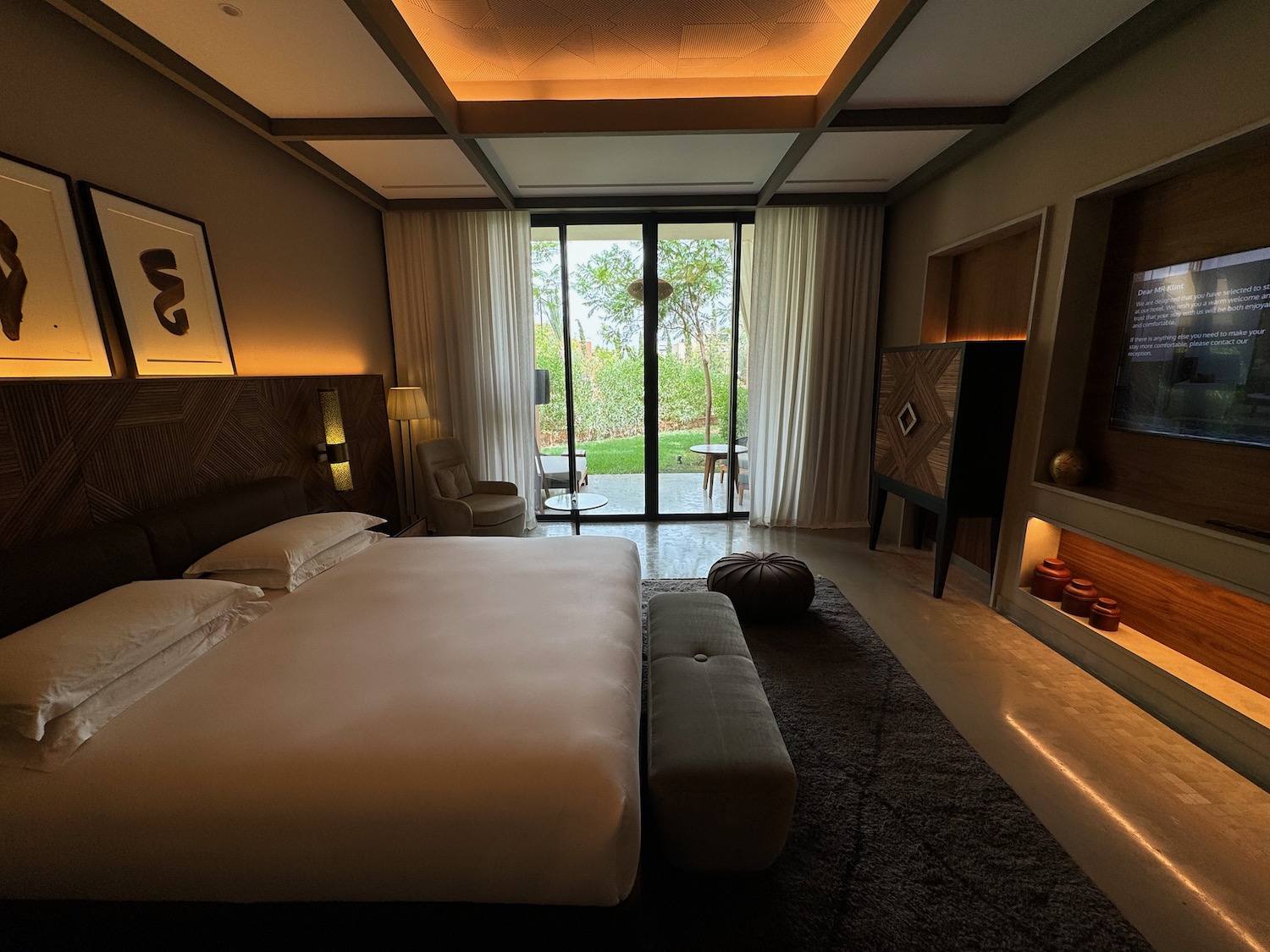 a bedroom with a bed and a glass door