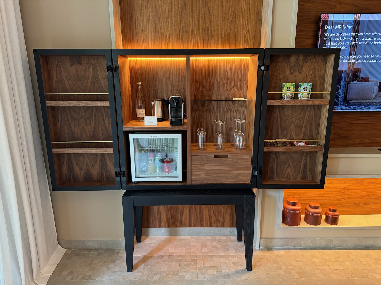 a cabinet with a shelf and a door open