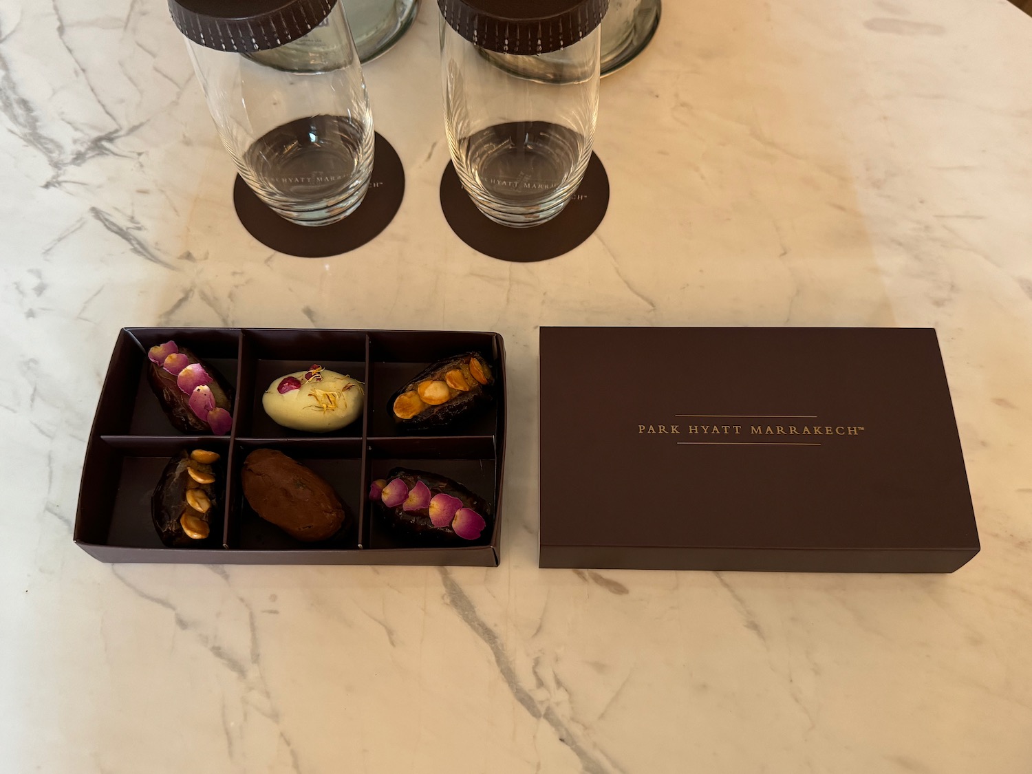 a box of chocolates and glasses on a table