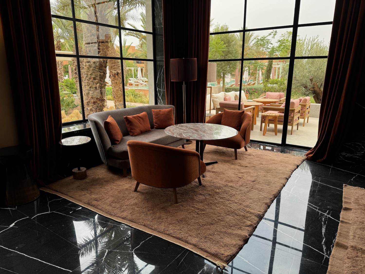 a room with a couch and chairs