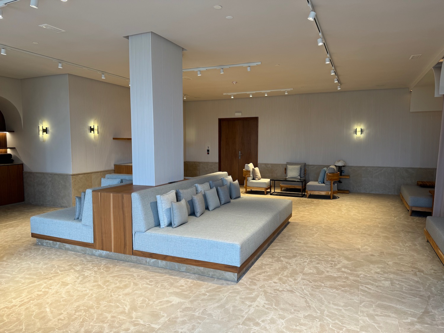a room with a large couch and chairs