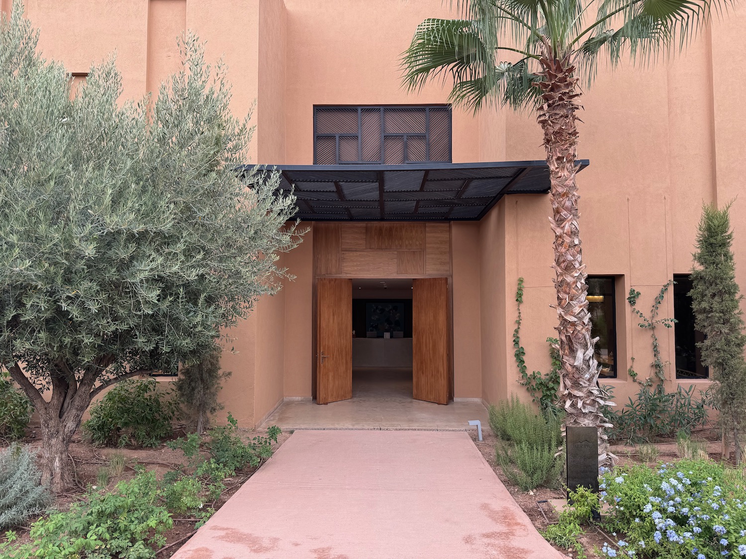 a building with trees and a walkway
