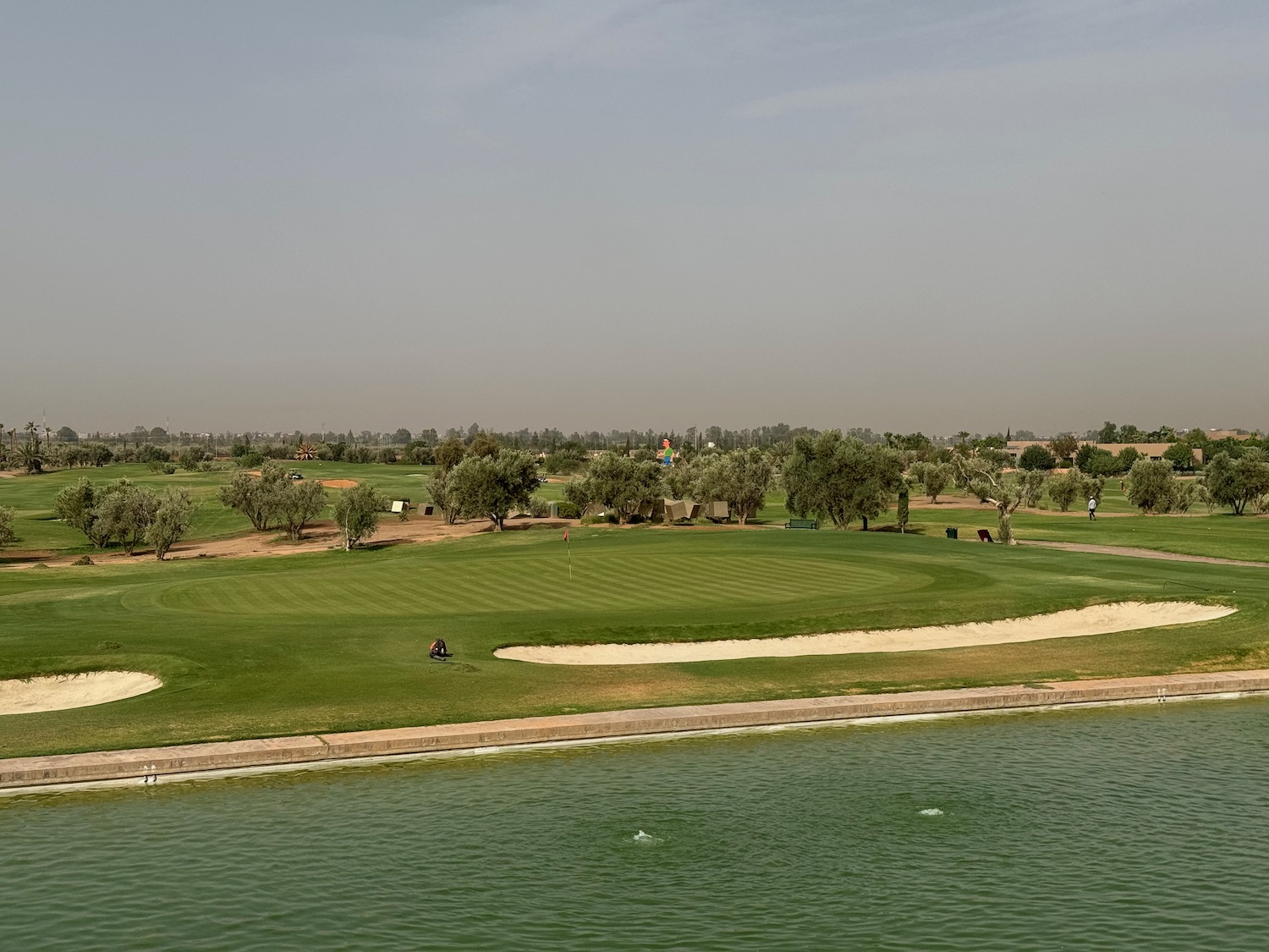 a golf course with a body of water