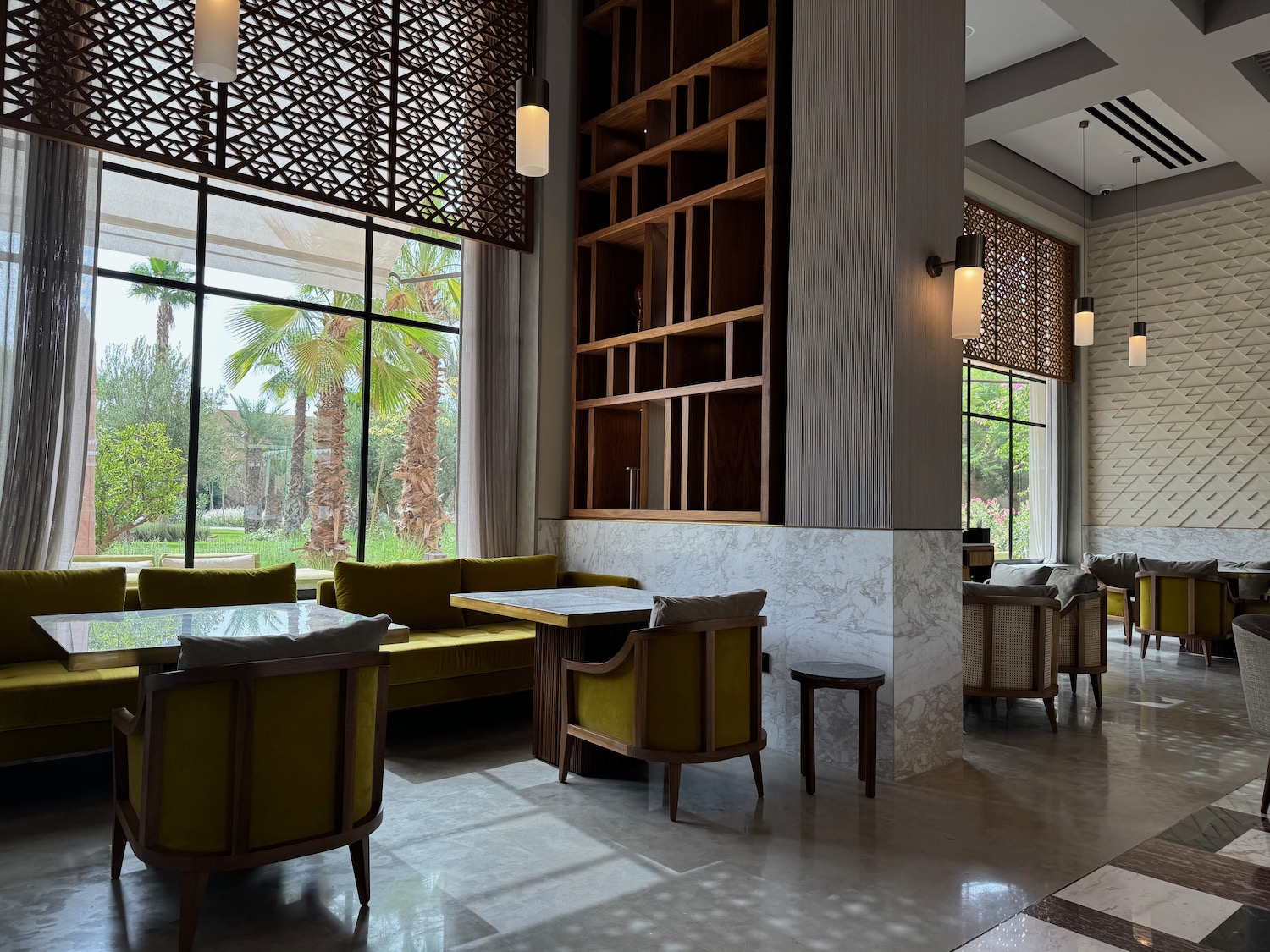a room with a large window and tables and chairs