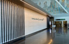 a large lobby with a wall and a mural on the wall