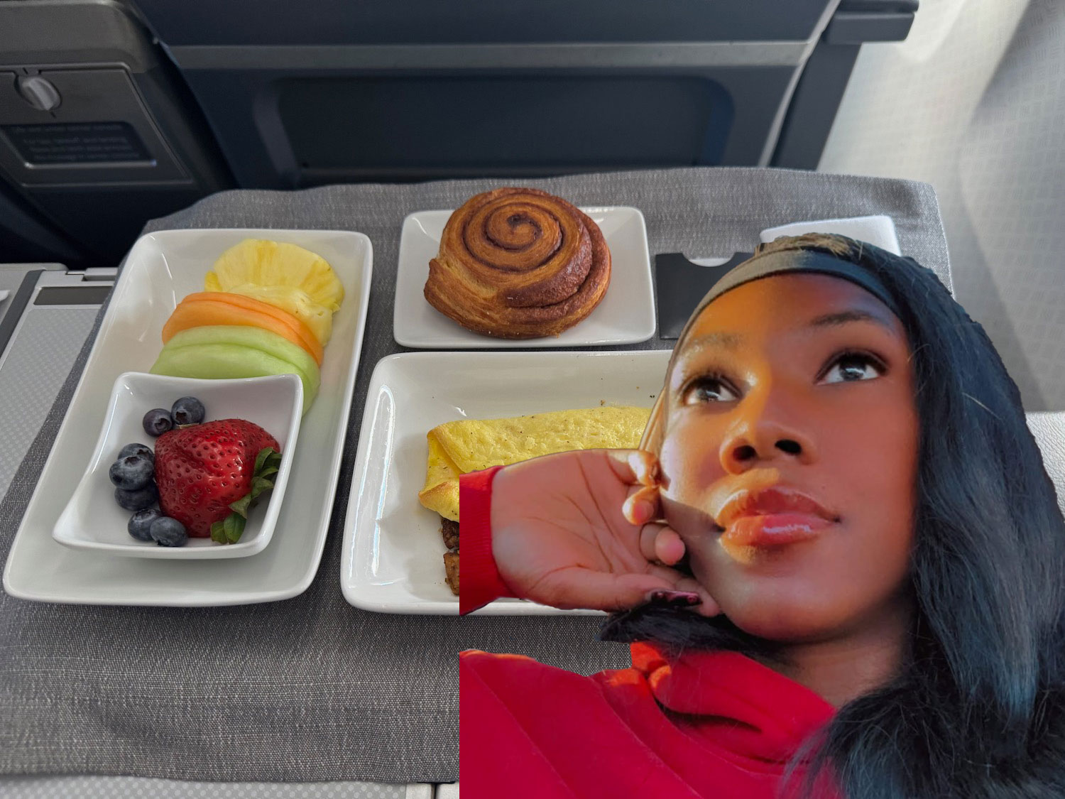 a woman taking a selfie with food on plates
