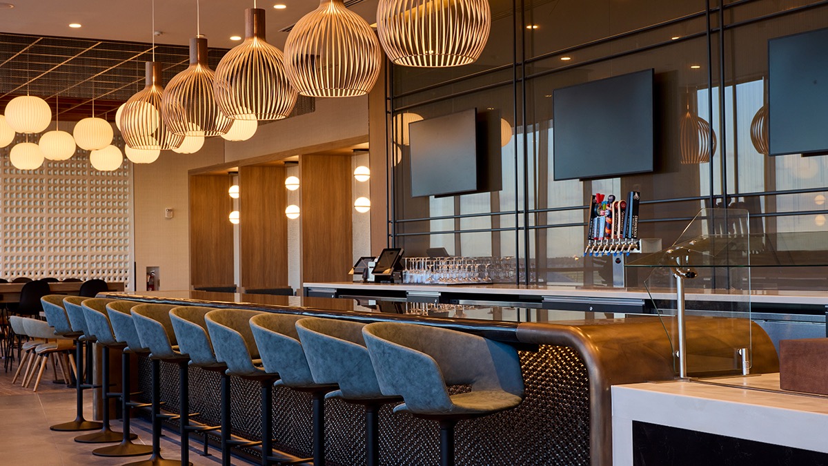 a bar with chairs and a tv