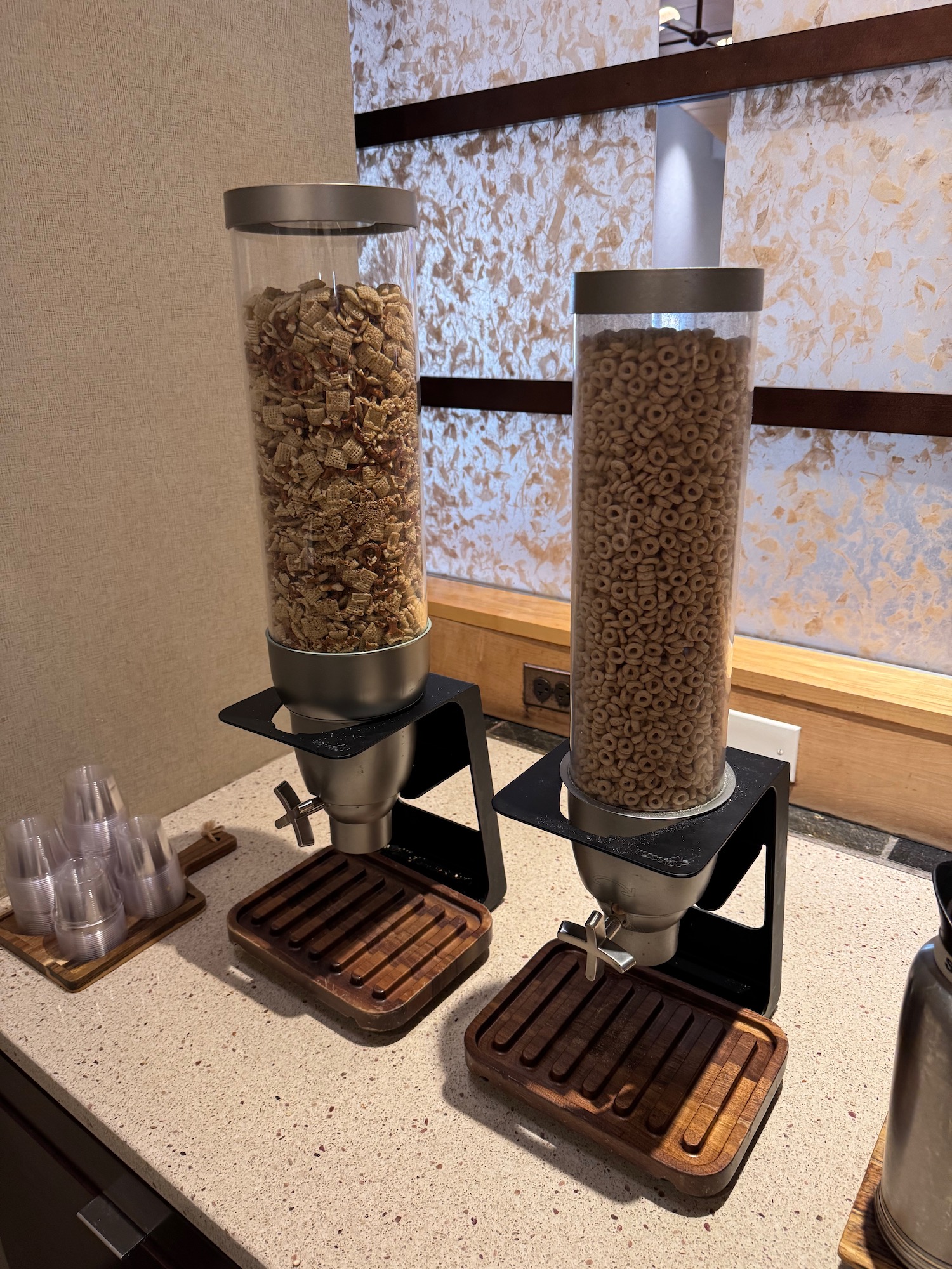 a two containers of cereal and a drink dispenser