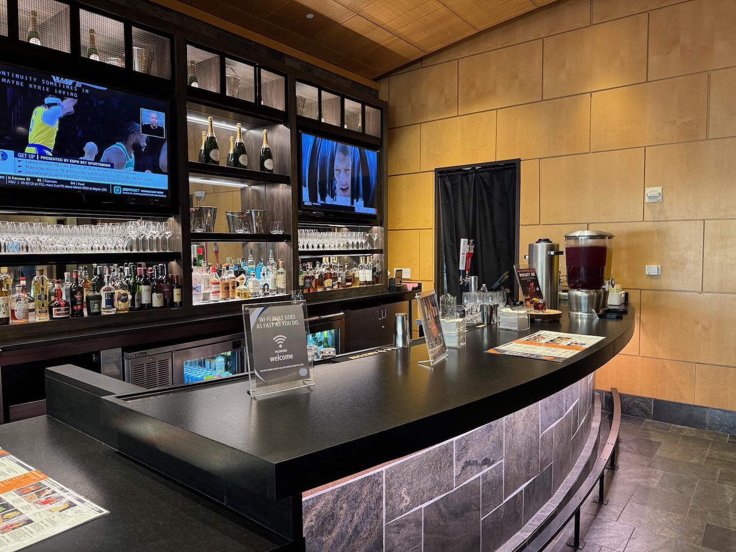 a bar with a counter and a television on the wall