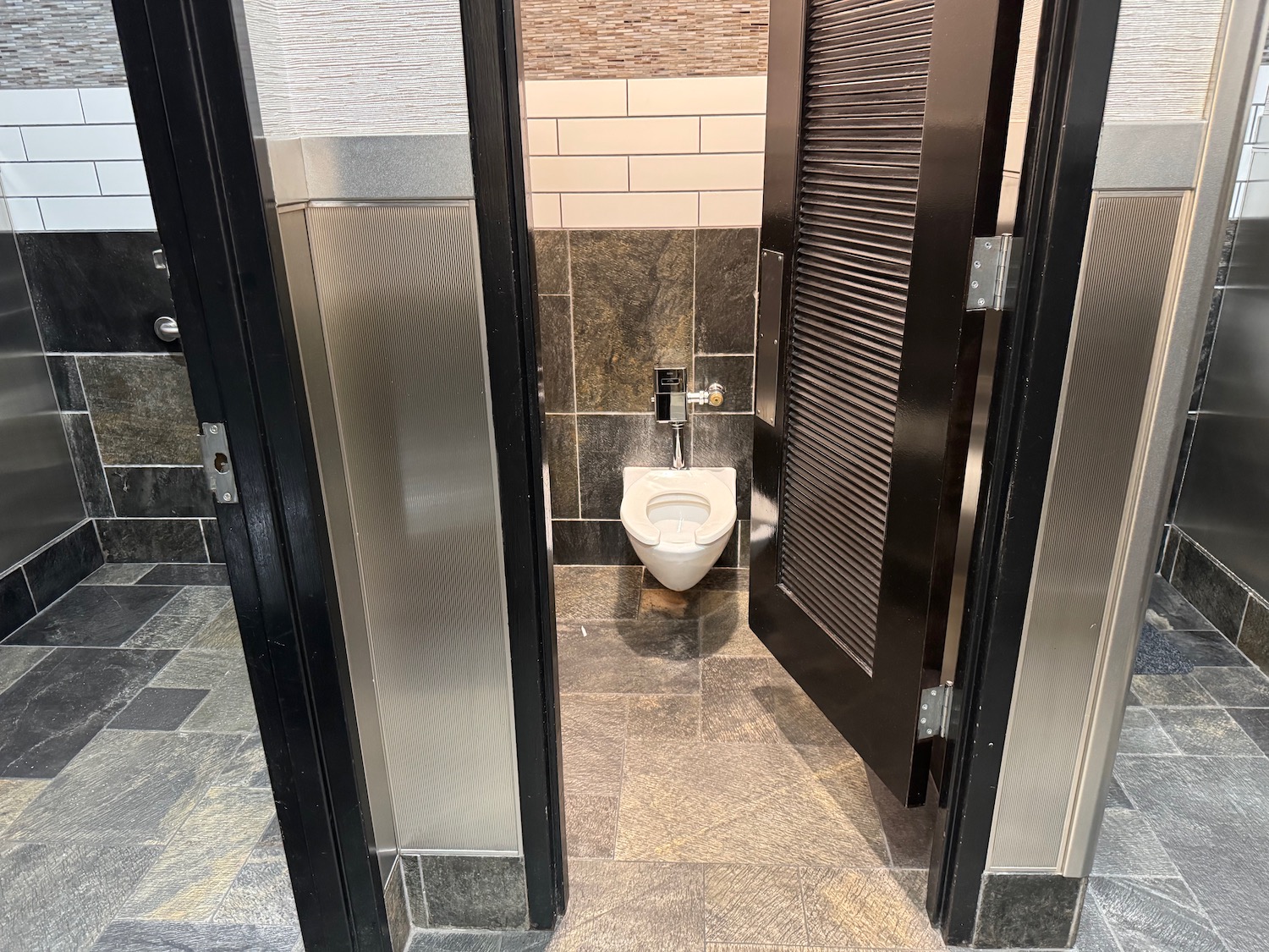 a bathroom with a toilet and a door