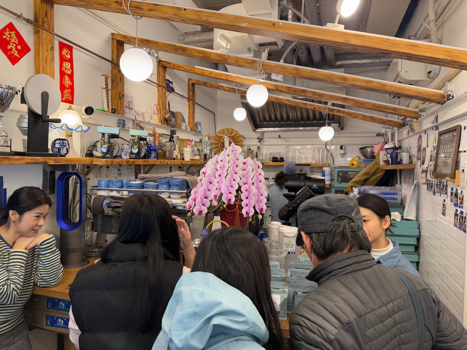 a group of people in a room with shelves and lights