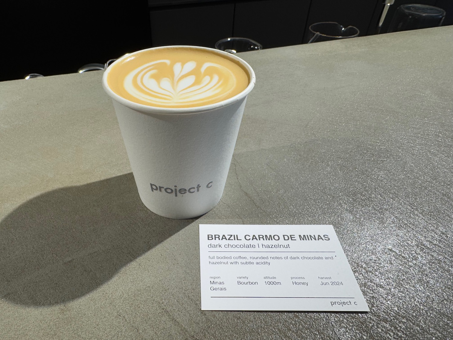 a cup of coffee with a leaf design on top of it