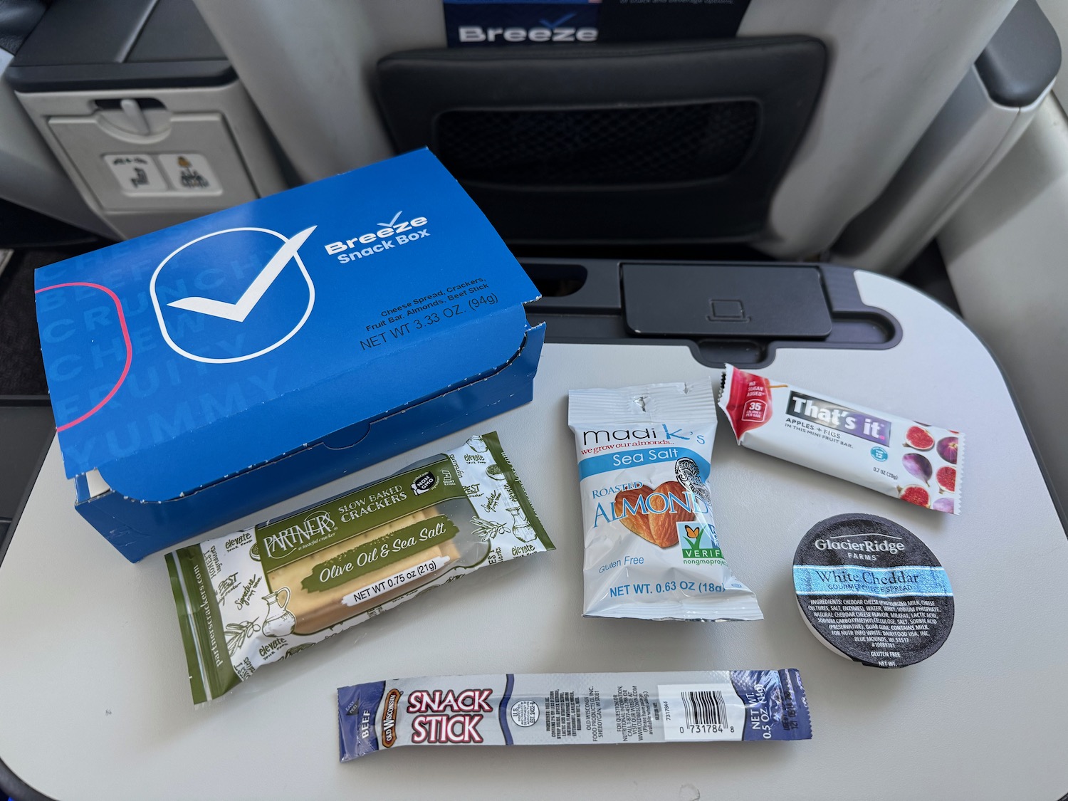 a blue box with a blue label next to a group of snacks on a table