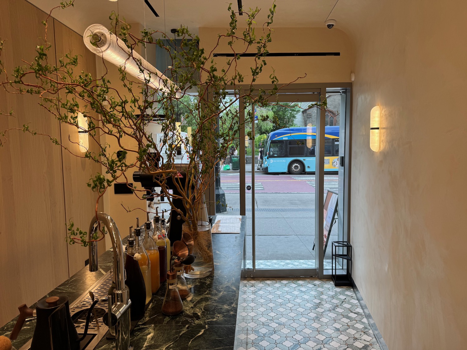 a coffee shop with a tree and a glass door