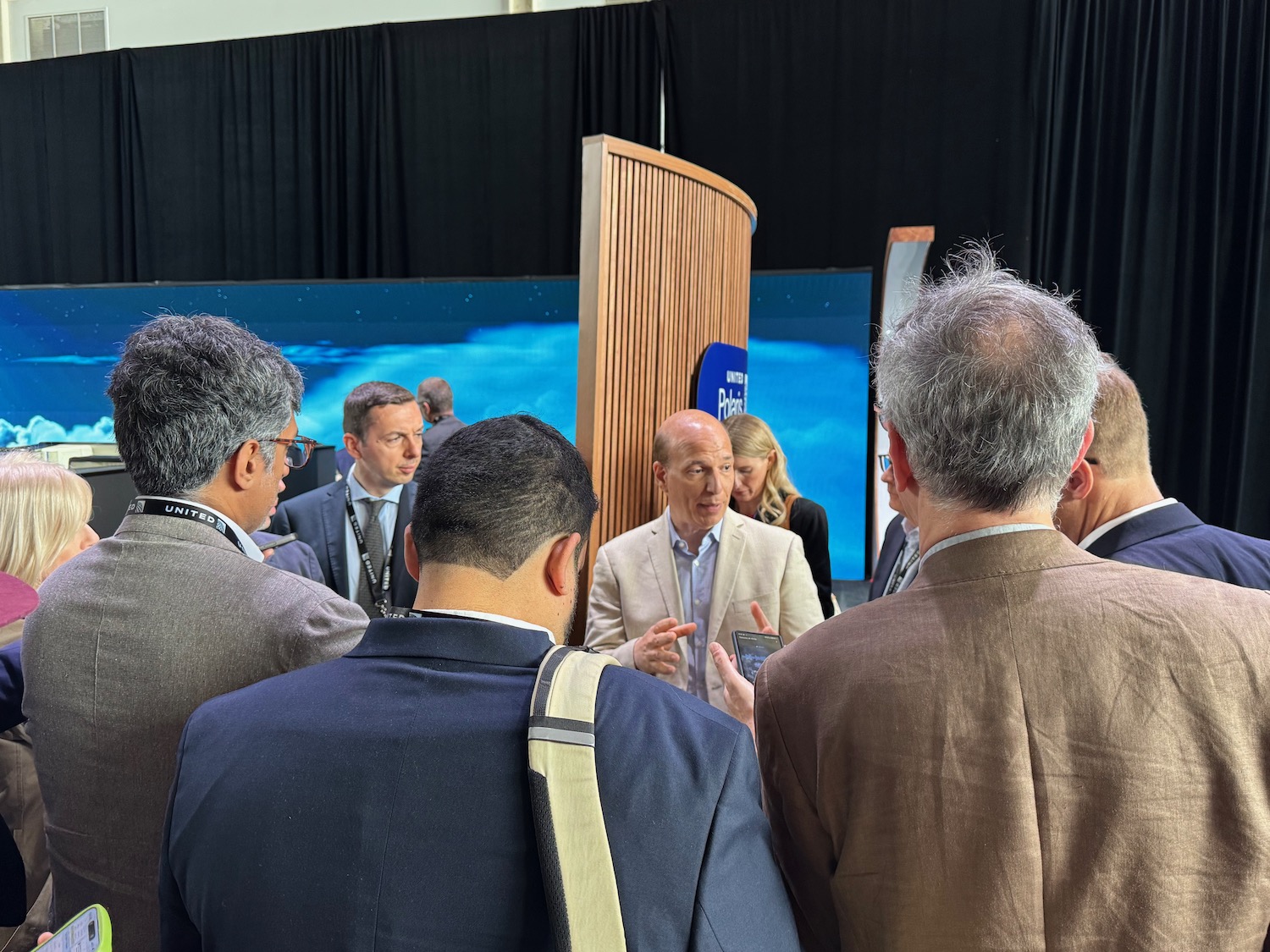 a group of people standing around a podium