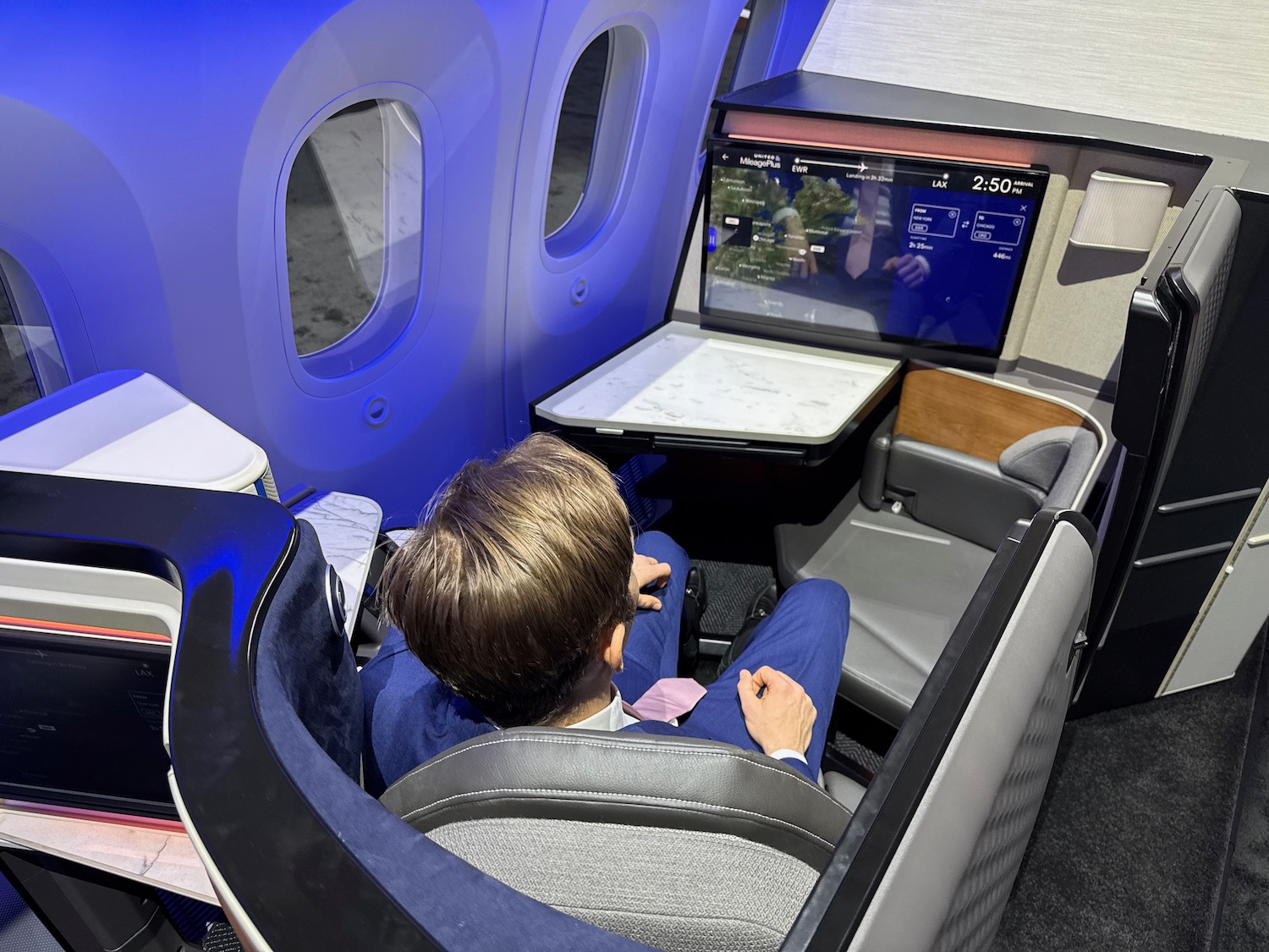 a man sitting in a chair in a plane