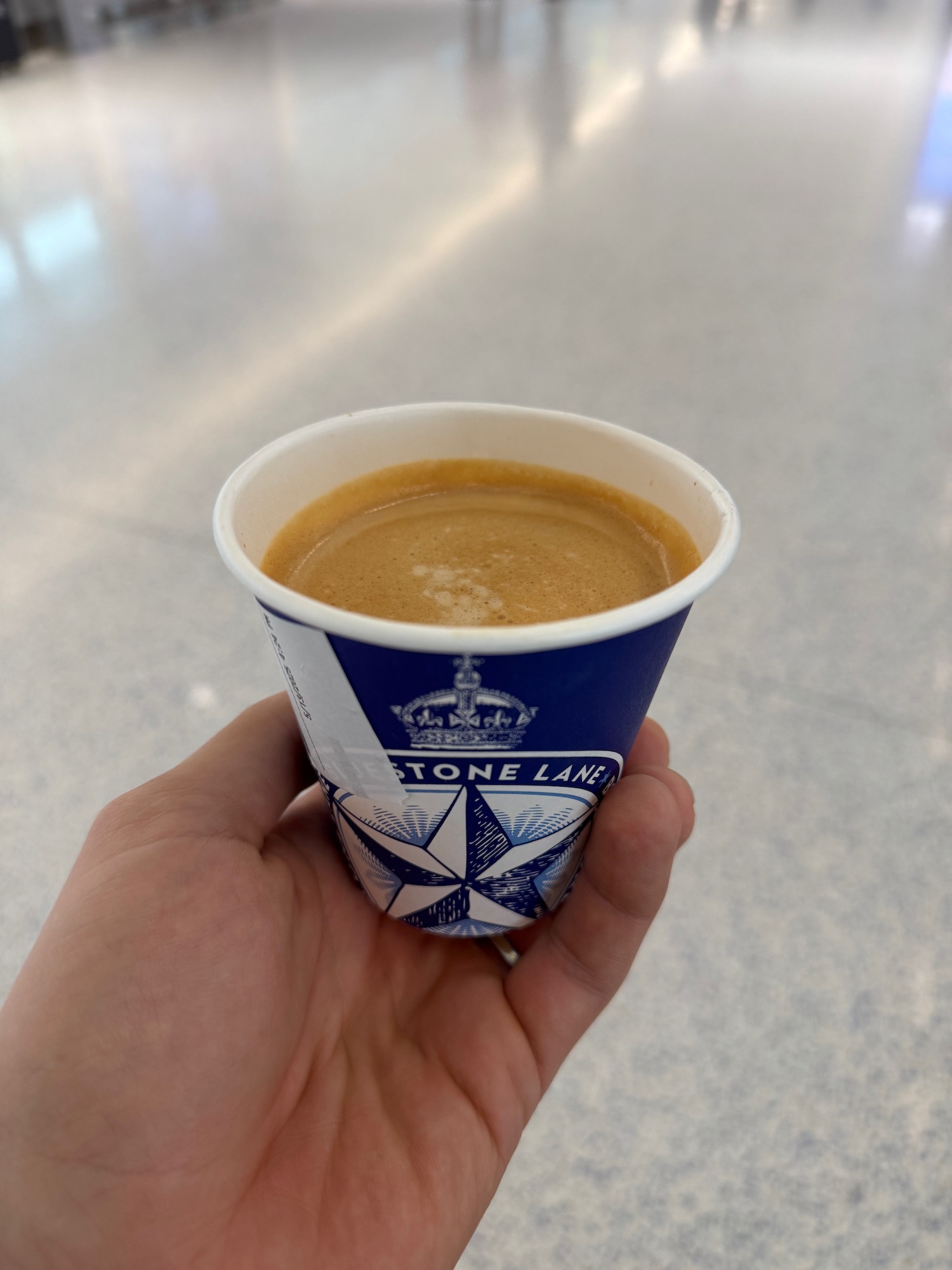 a hand holding a cup of coffee