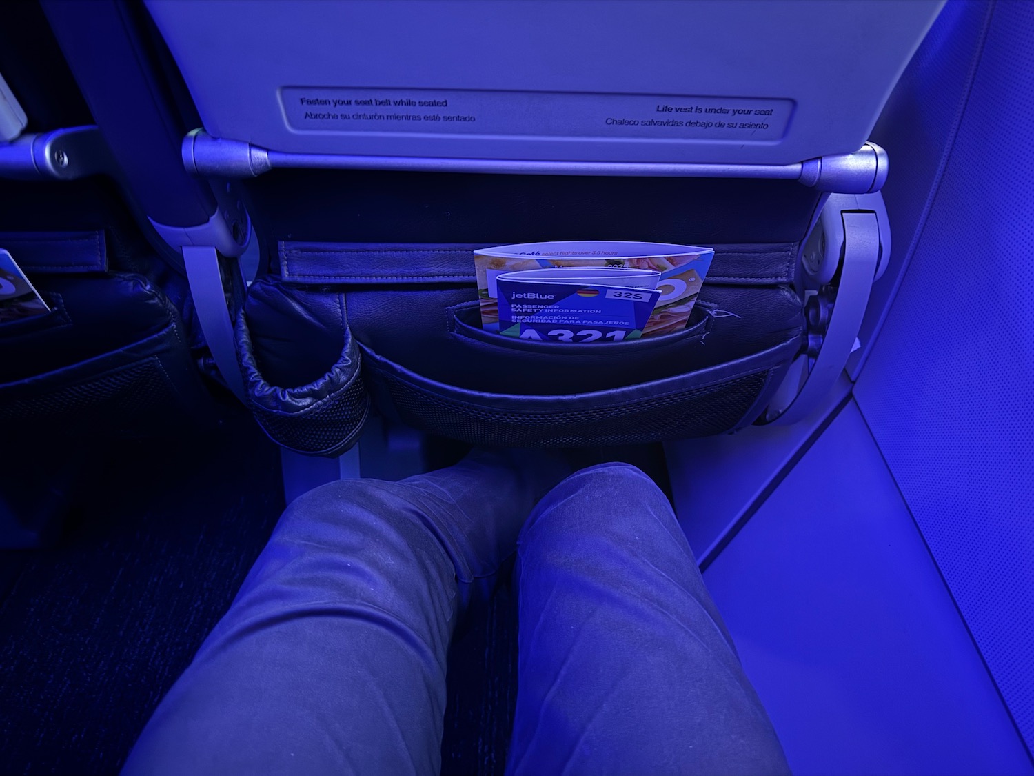 a person's legs in a pocket with a ticket in the pocket