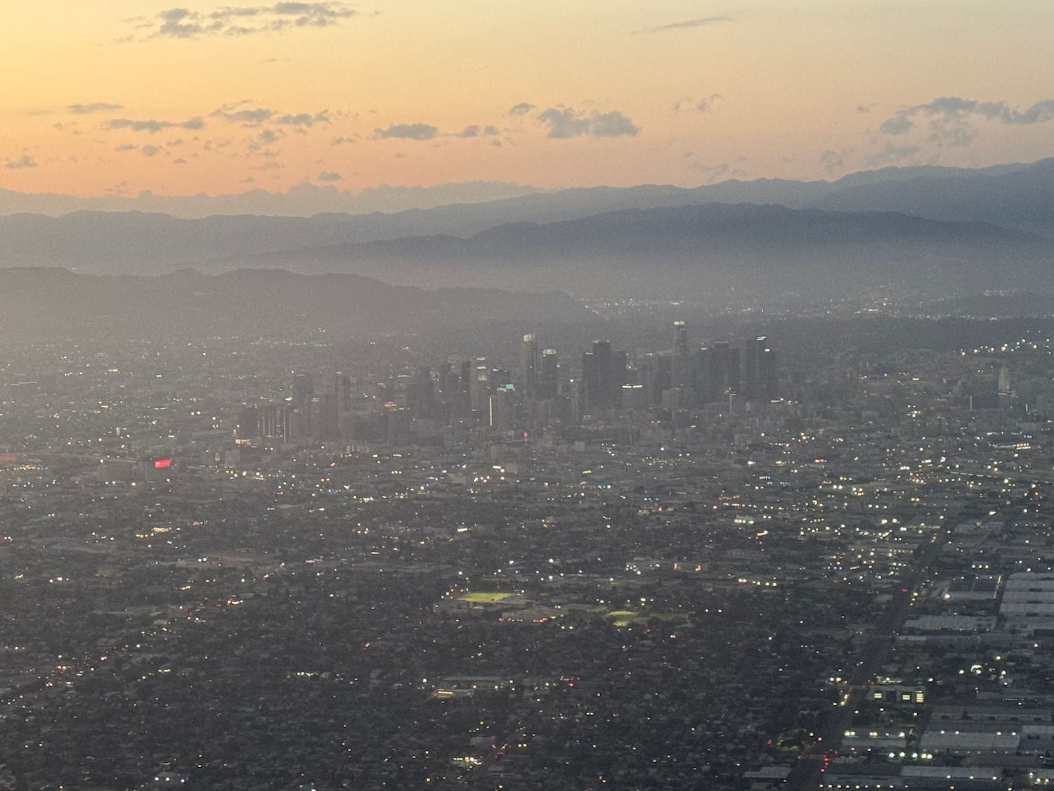 a cityscape with mountains in the background
