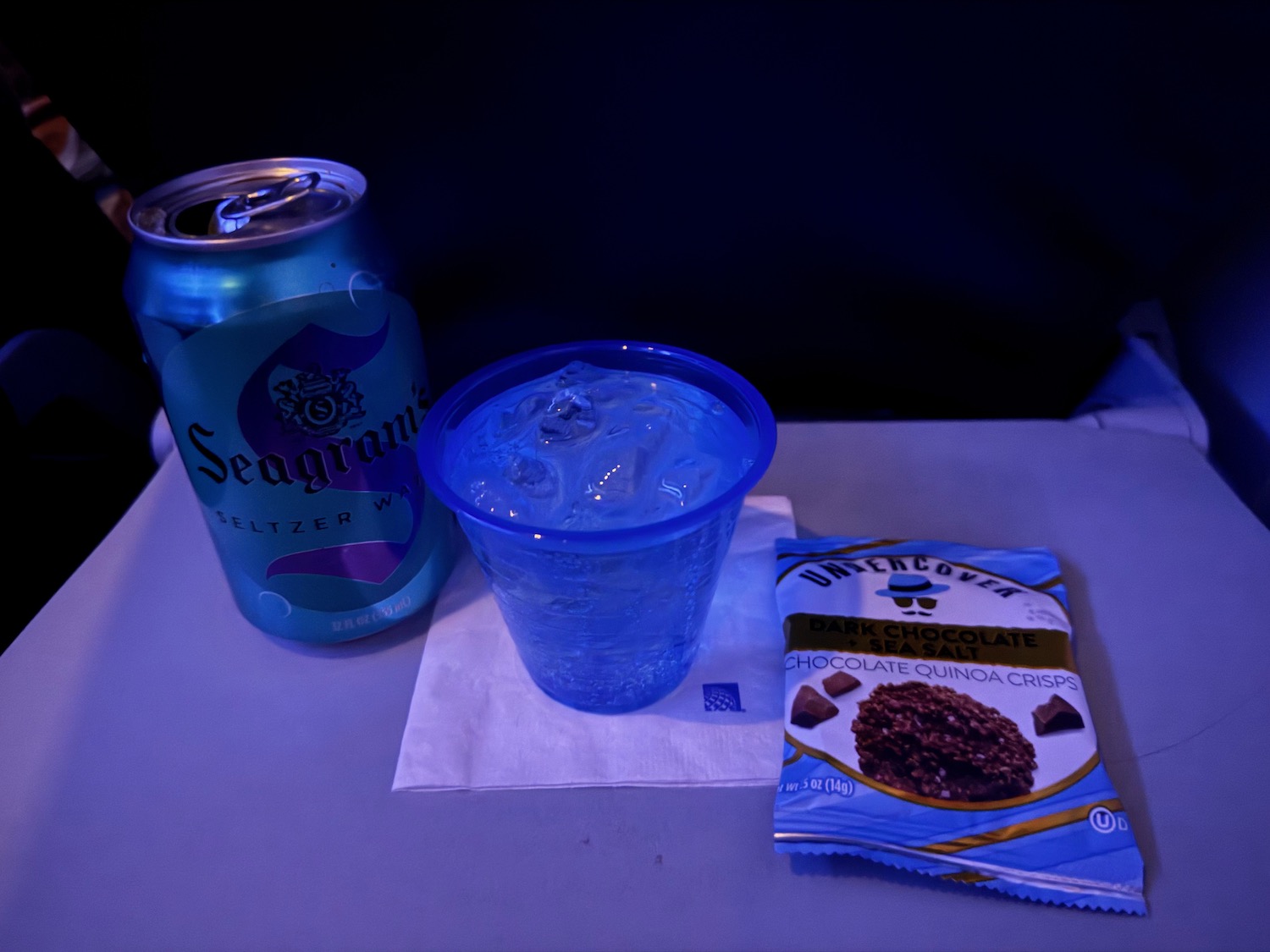a can of soda and a cup of liquid