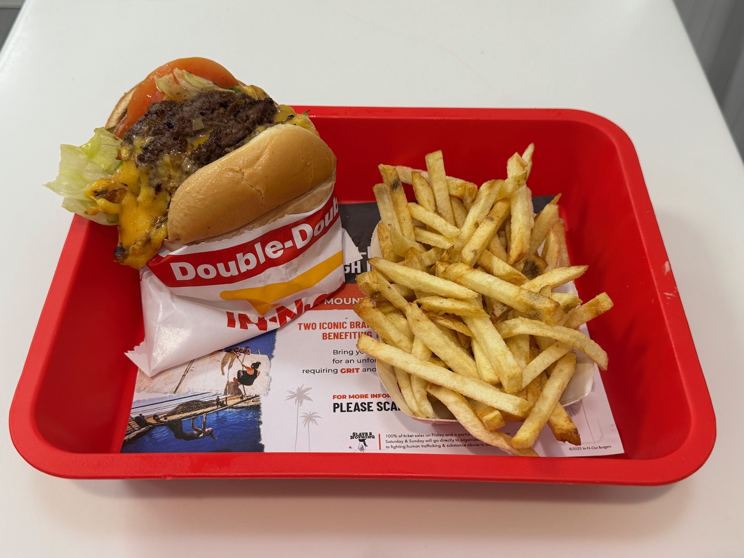 a burger and fries in a red tray