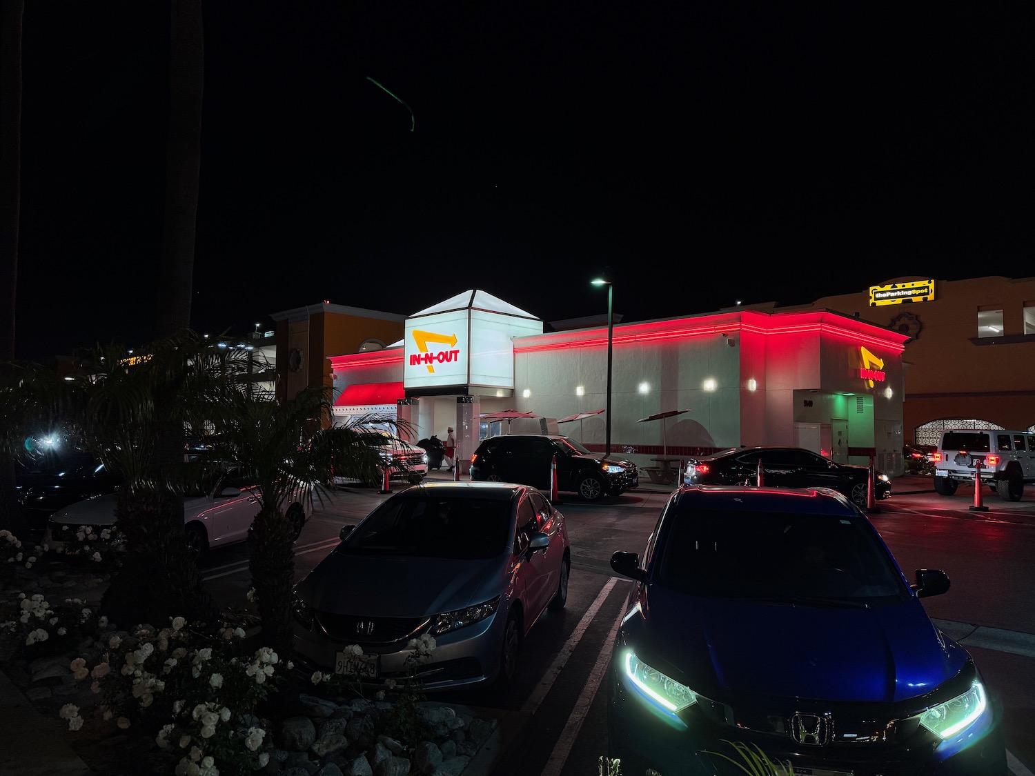 a building with cars parked in front of it at night