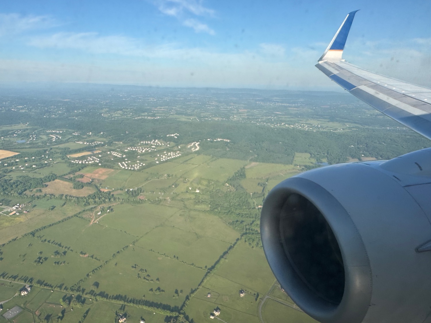an airplane wing and a landscape