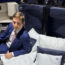 a man in a suit sitting on a bed