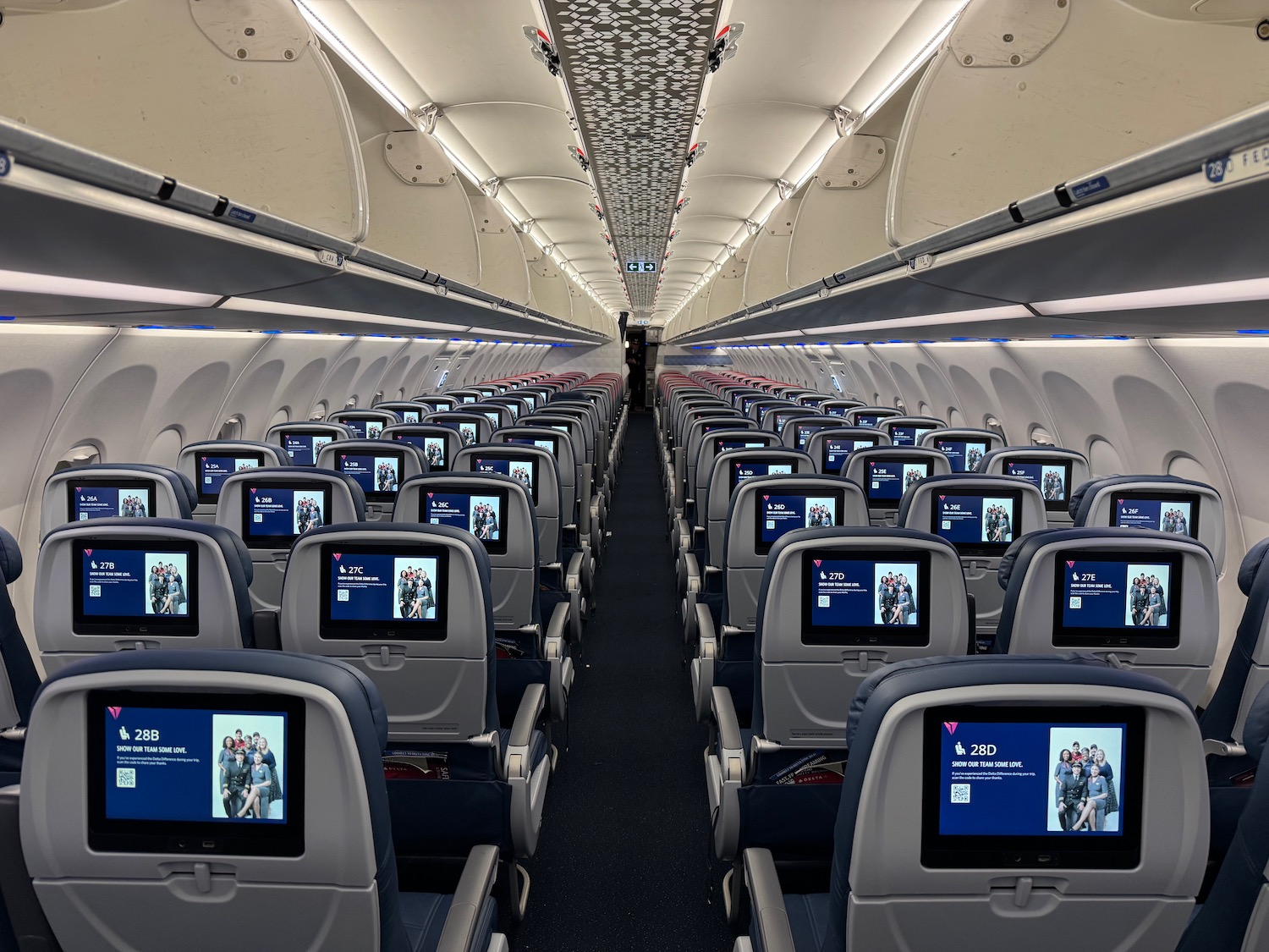 an airplane with rows of seats and monitors