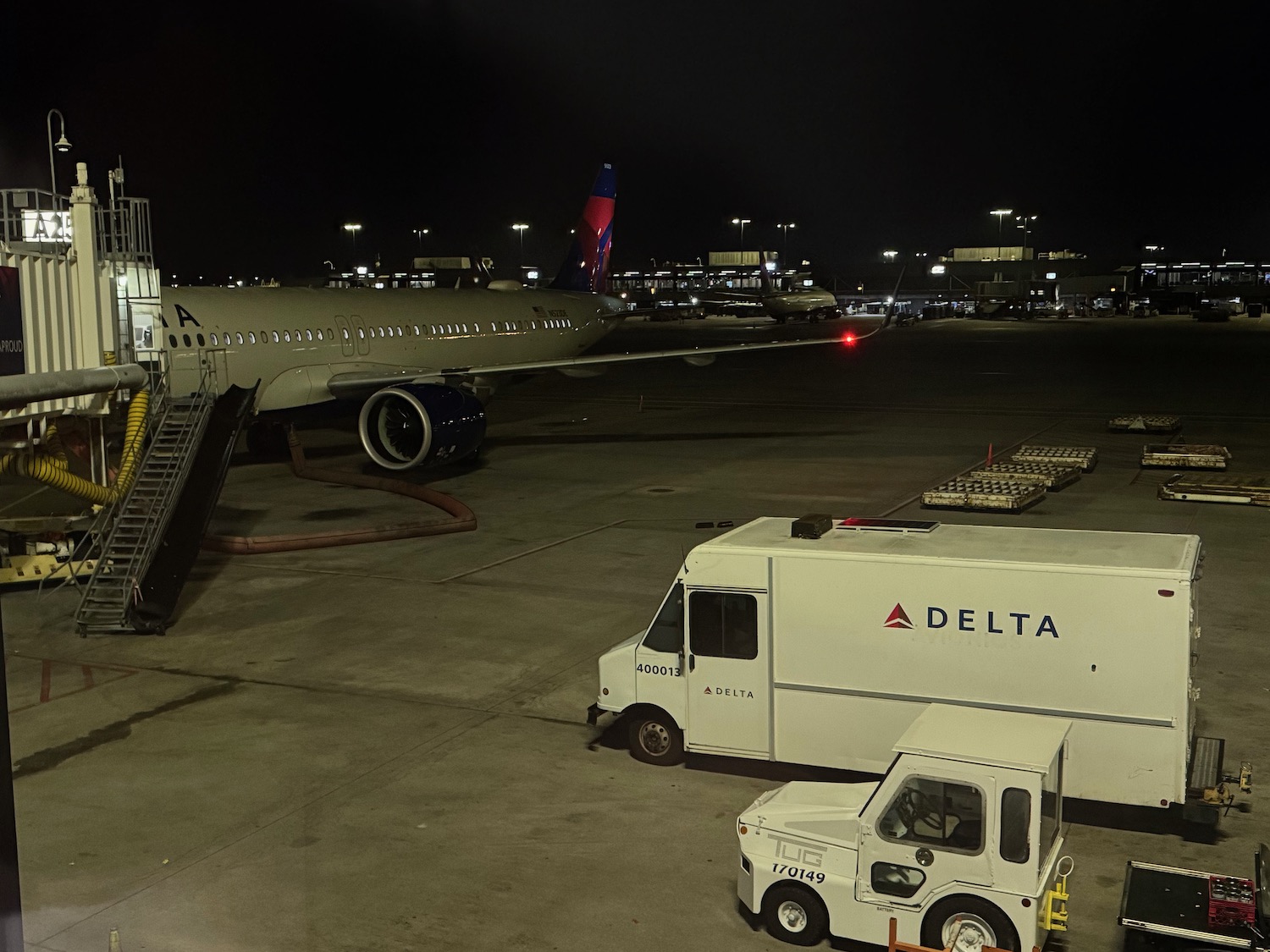 a plane and delivery truck at an airport