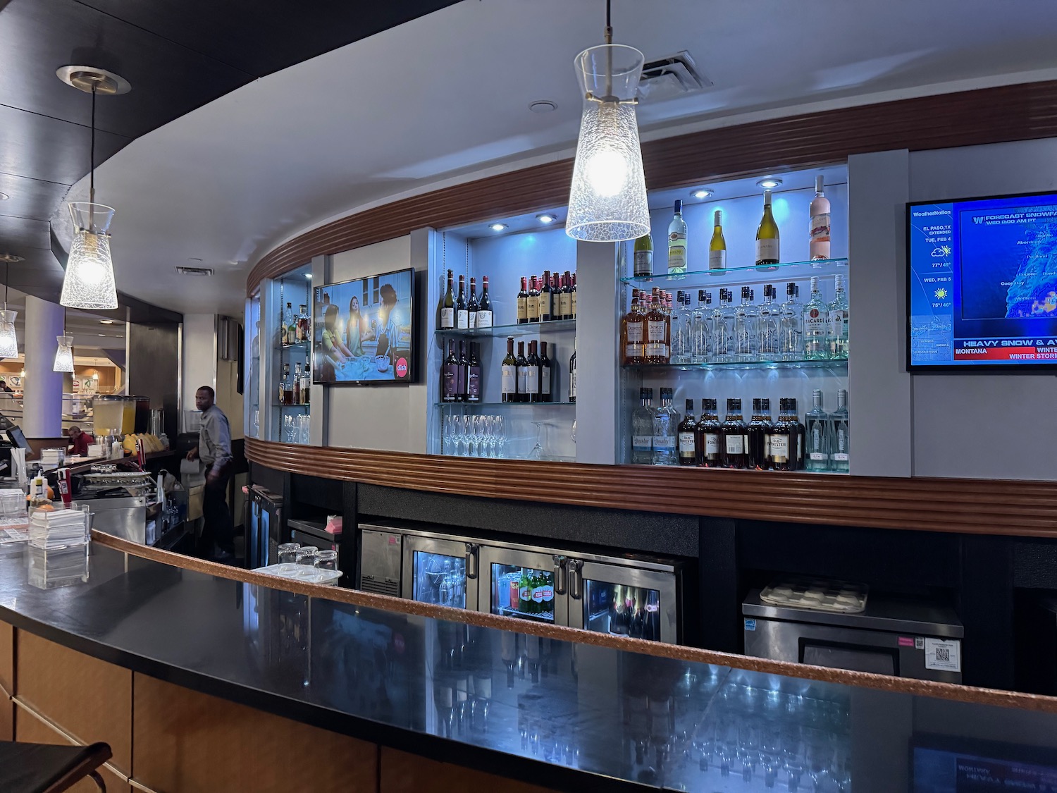 a bar with a television and bottles of alcohol