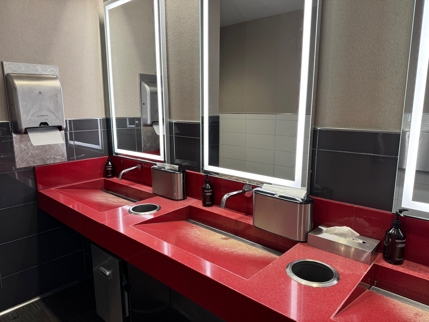 a red countertop with a large mirror