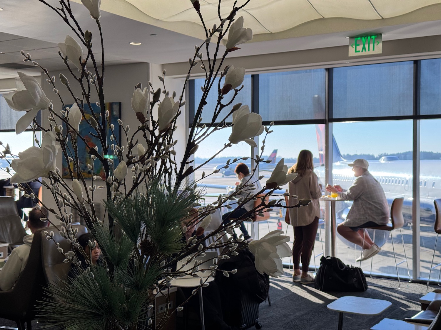 a group of people in a room with a large window