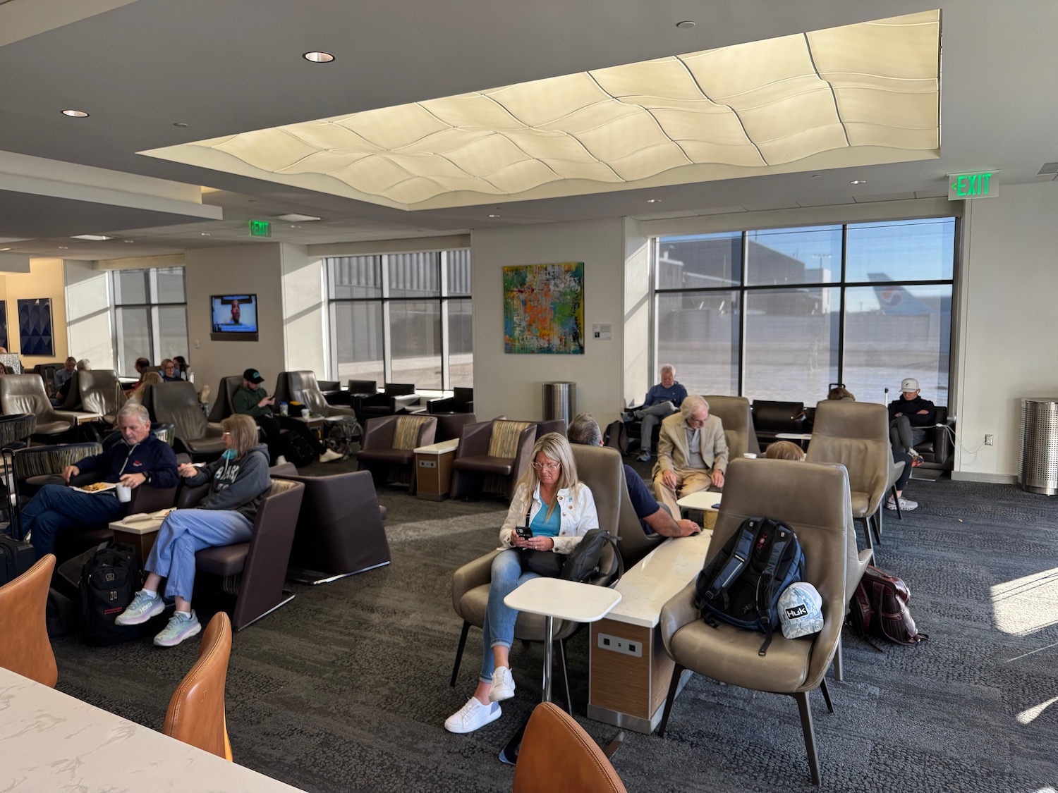 people sitting in chairs in a lounge