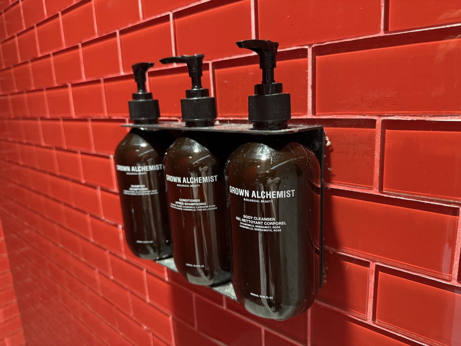 a group of soap dispensers on a wall