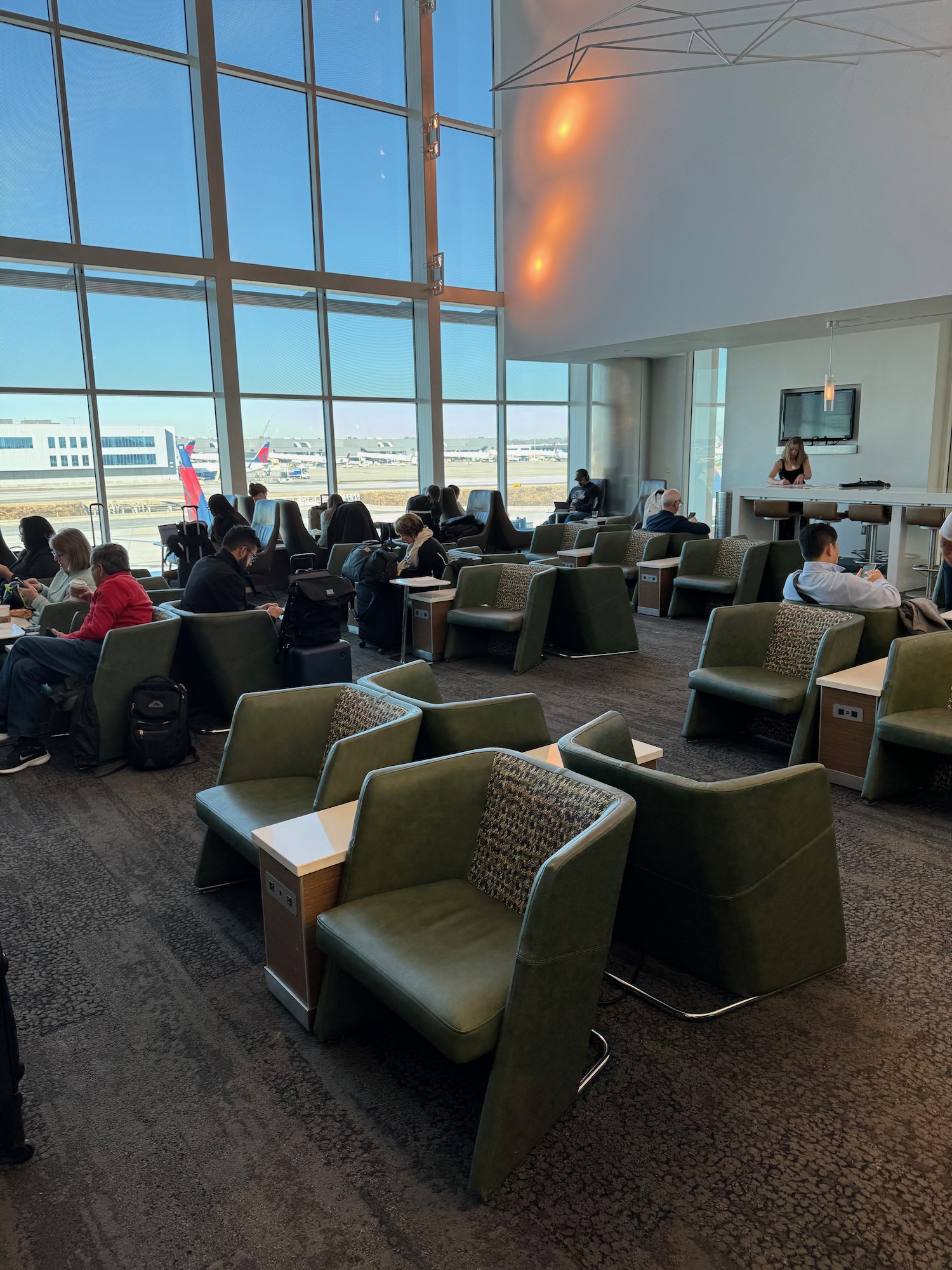 a group of people sitting in a room with windows