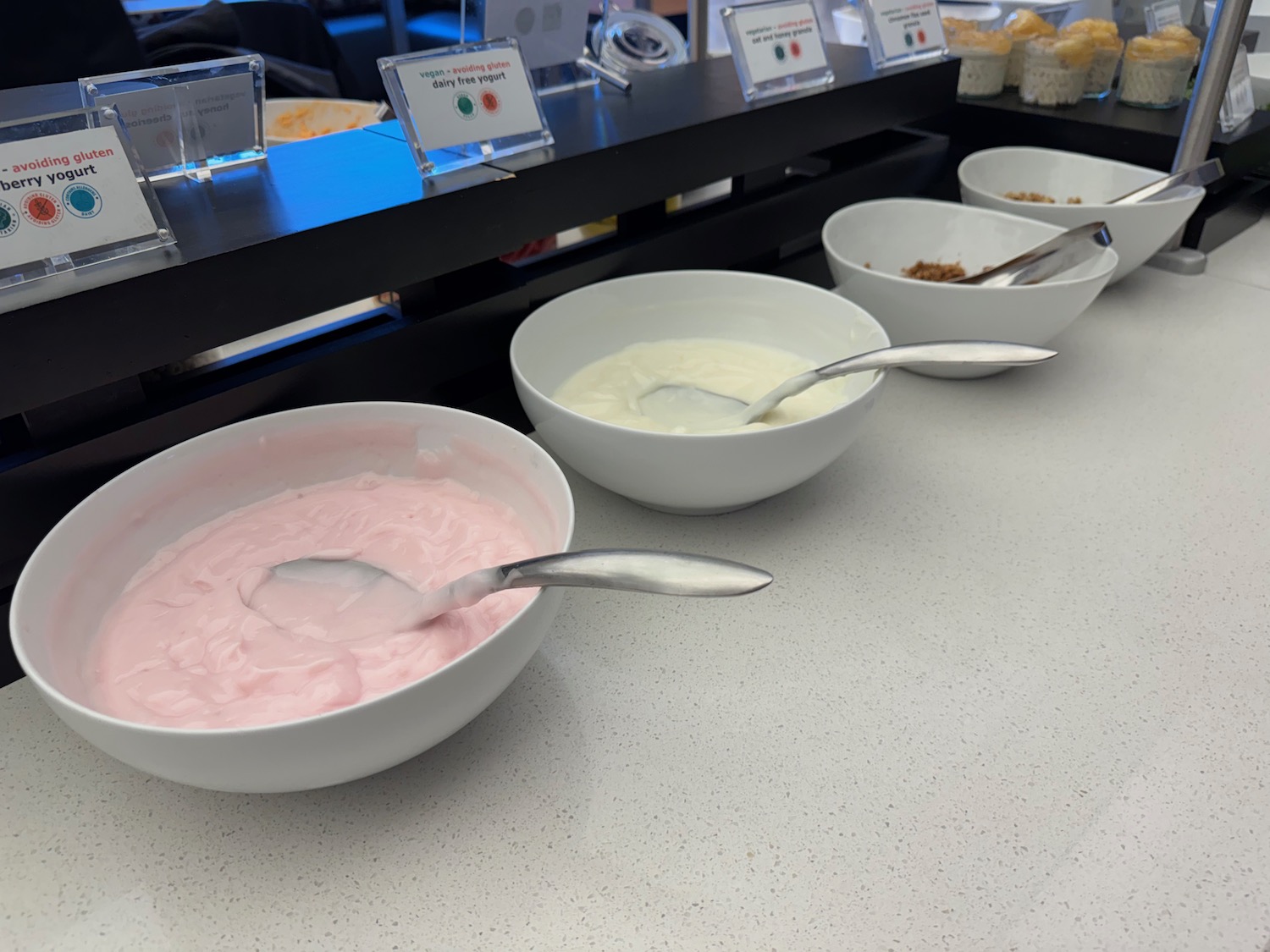a group of bowls of yogurt and other food