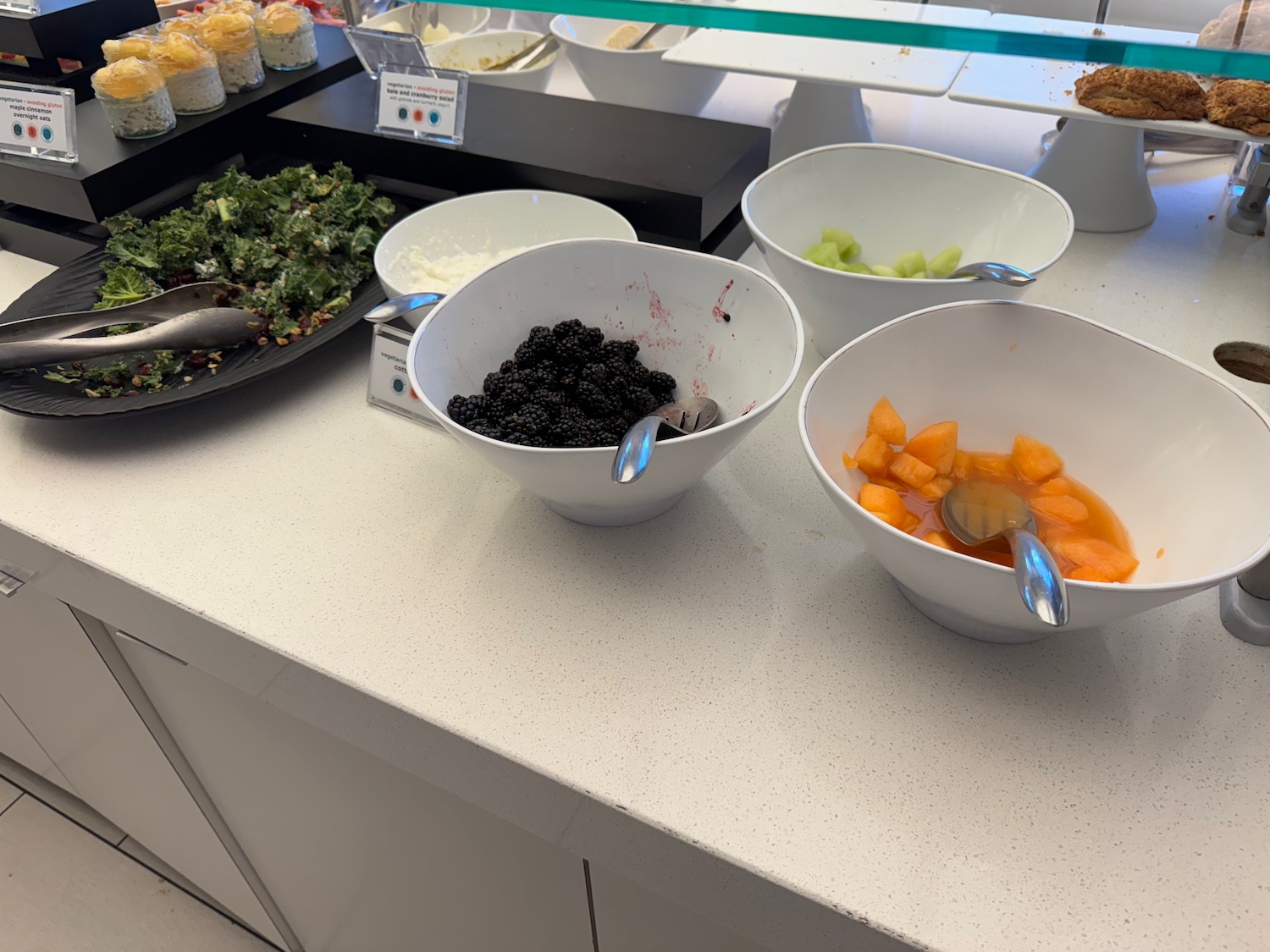 a group of bowls of fruit and vegetables on a counter